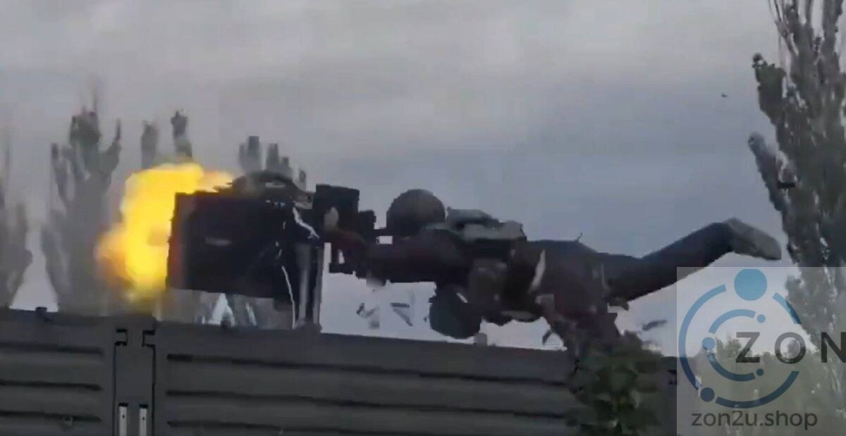 A soldier in tactical gear is thrown backward by a large explosion from a piece of heavy equipment